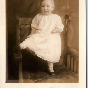 c1910s Cute Baby Portrait RPPC Standing Chair Cute Boy Kicks Real Photo PC A254