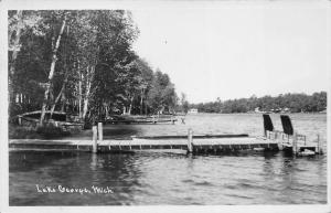 Lake George Michigan 1954 RPPC Real Photo Postcard Island Lake Dock Lounge Chair