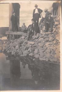 GROUP OF MEN & DOG~ONE MAN HAS RIFLE~RIP RAP AT PIER OR DOCK REAL PHOTO POSTCARD