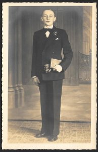 Young Man in Suit Bow Tie & Holding Gloves & Book RPPC Unused c1910s