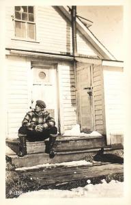 RPPC, UNALASKA, AK Alaska    A SOURDOUGH Sitting on Snowy Porch  c1940s Postcard