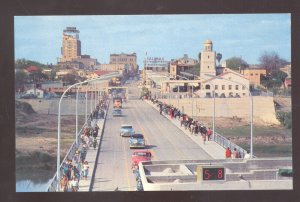 LAREDO TEXAS INTERNATIONAL BRIDGE OLD CARS STREET SCENE VINTAGE POSTCARD