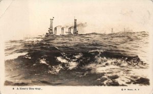RPPC SHIP IN STORMY WEATHER MILITARY REAL PHOTO POSTCARD (c. 1920s)