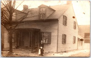 Young Woman and Daughter Stand Outside Home During Winter - Vintage Postcard