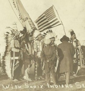 Mott NORTH DAKOTA RPPC 1918 SIOUX INDIANS Indian Trading WHITE MAN Trader FLAG 