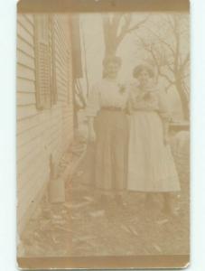 Faded circa 1910 rppc TWO WOMEN IN DRESSES BY HOUSE WITH SHUTTERS o2710