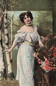 Pretty Lady Picking Flowers Long Gown Yellow Ties Vintage Postcard