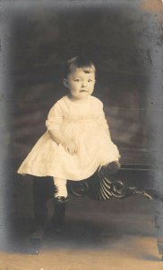 1920s RPPC Real Photo Postcard Baby Toddler Seated On Shell Carved Bench