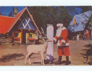 Pre-1980 SANTA CLAUS FEEDS REINDEER AT NORTH POLE Wilmington NY E6869