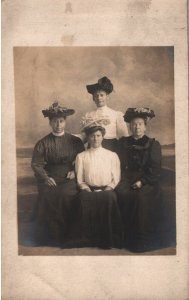 VINTAGE POSTCARD GROUPING FOUR WOMEN IN PERIOD HATS REAL PHOTO STUDIO LISTED