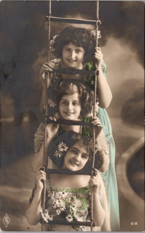 Hand Colored Real Photo Postcard Photo Studio Three Girls Faces in Rope Ladder