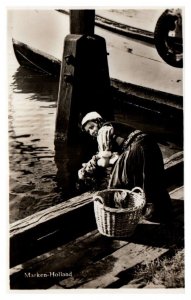 Dutch woman washing clothes in water off a dock Marken Holland RPPC Postcard