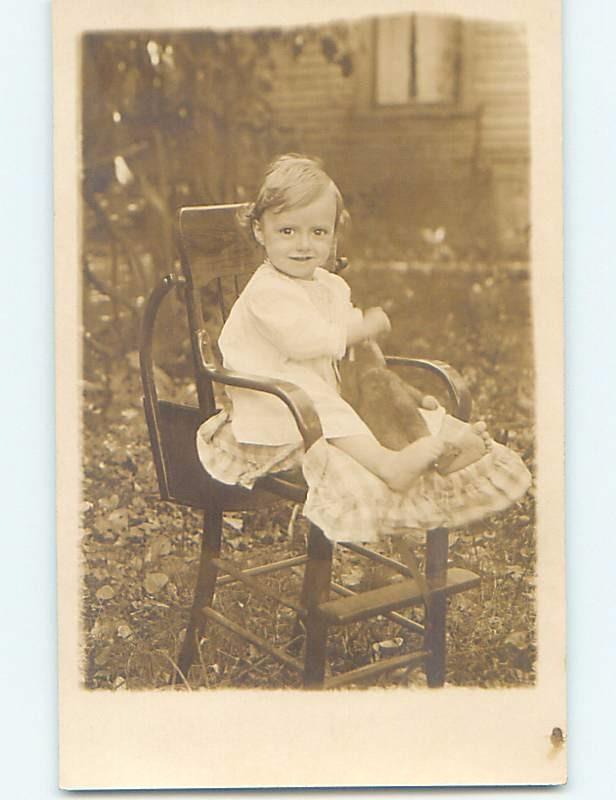 Pre-1918 rppc CHILD IN HIGH CHAIR HOLDING TEDDY BEAR HM3119