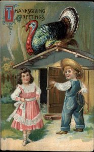 Thanksgiving Little Boy Farmer with Girl Chasing Turkey c1910 Postcard