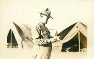 Military, Army Soldier Reading Note outside of Tent, RPPC