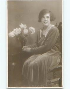 Old rppc GIRL POSES WITH VASE OF FLOWERS Surrey - Embossed Guildford UK o1576