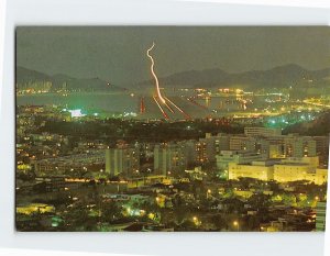 Postcard View of plane making a night landing at Kaitak, Hong Kong, China