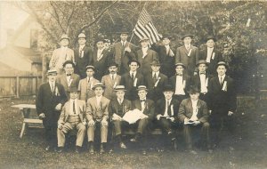 Postcard RPPC C-1910 Group men patriotic flag ribbons well dressed men 23-11607