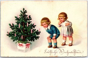 VINTAGE POSTCARD ANIMATED GERMAN BOY AND GIRL AT CHRISTMAS TREE MAILED 1930s