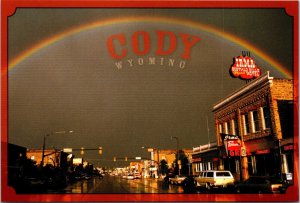 Street View with Rainbow of Cody Wyoming Postcard Irma Hotel Restaurant