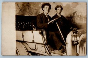 c1910's Two Men Cigarette Riding Car Props Studio RPPC Photo Antique Postcard