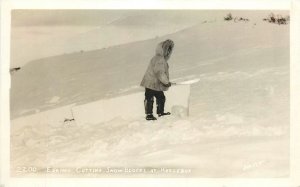 Postcard RPPC 1920s Alaska Eskimo cutting snow blocks Kotzebue Johnston  24-6433