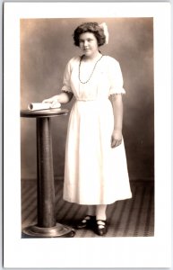 Young Woman in Long White Dress and Hair Bow with Diploma - Vintage Postcard