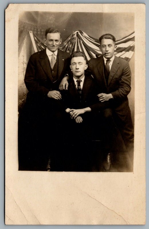 Postcard RPPC c1907 Studio Photo Of 3 Men American Flag Tobacco Pipe Patriotic