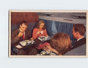 Postcard Group enjoying dinner, United's DC-6 Mainliner 300's smart club-car