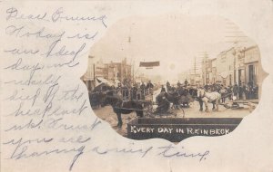 J48/ Reinbeck Iowa RPPC Postcard c1910 Horses Wagons Stores  Busy 227