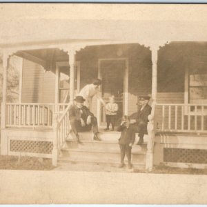 c1910s Handsome Little Boys Family Porch RPPC Conductor Man Smoking Photo A139