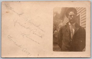 Great Bend Kansas c1910 RPPC Real Photo Postcard Man In Tie Standing by House