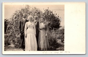 c1912 RPPC Two Men & Two Women Pose in Front of Bush ANTIQUE Postcard 1334