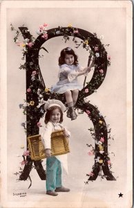 Hand Colored Real Photo Postcard Children Sitting in Large Letter R with Flowers