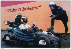 Policeman gives go-cart driver a ticket , 60-80s, In-door G0-Kart Facility, V...