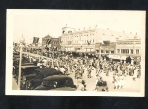 RPPC DOWNTOWN STREET SCENE PARADE STORES OLD CARS REAL PHOTO POSTCARD WHERE?