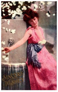 Woman, Sexy  Beautiful,Pink Dress leaning on water fountain