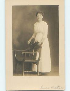 Pre-1920's rppc ANTIQUE CARVED WOODEN CHAIR IN FRONT OF WOMAN HM0658