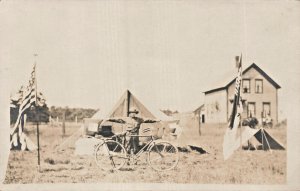 UNITED STATES SOLDIER CAMP-BICYCLE-FLAGS-TENT~REAL PHOTO POSTCARD