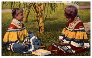 Seminole Indian Girl's stringing beads  Florida