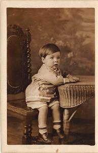 Young boy sitting on a chair 1 year & 9 months Child, People Photo Writing on...