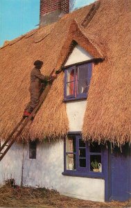 UK England countryside man thatching a roof