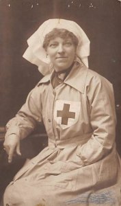 Nurse in Red Cross Uniform Writing on Back 