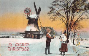 CHILDREN WINDMILL CHRISTMAS HOLIDAY HOLD TO LIGHT NOVELTY POSTCARD (c. 1910)