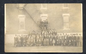 RPPC TO CHAMBERS NEBRASKA GROUP OF MEN AT LARGE BUILDING REAL PHOTO POSTCARD