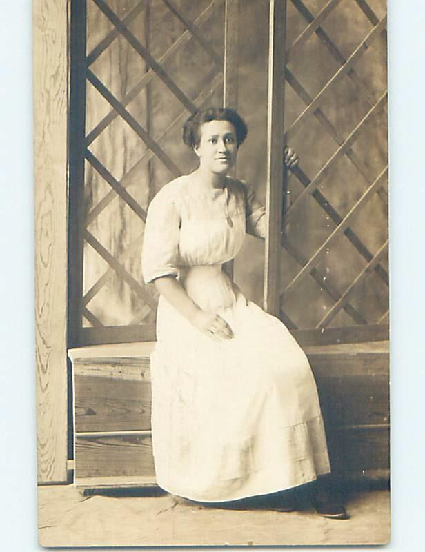 Pre-1918 rppc architecture CROSSHATCHED WOODEN WINDOW FRAMES BEHIND WOMAN HM0262