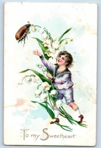 Charles City IA Postcard Boy Caching The Bug Lily Flowers Embossed Tuck 1909