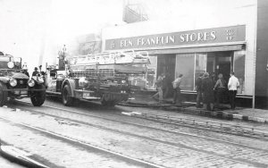 FIRE TRUCKS AT BEN FRANKLIN STORES POSTCARD (c. 1930s)