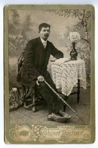 497955 man with cane reading book at table photo Dembinsky Kolpino CABINET PHOTO