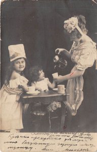 Lot350 woman with children at the table  hungary making tea social history